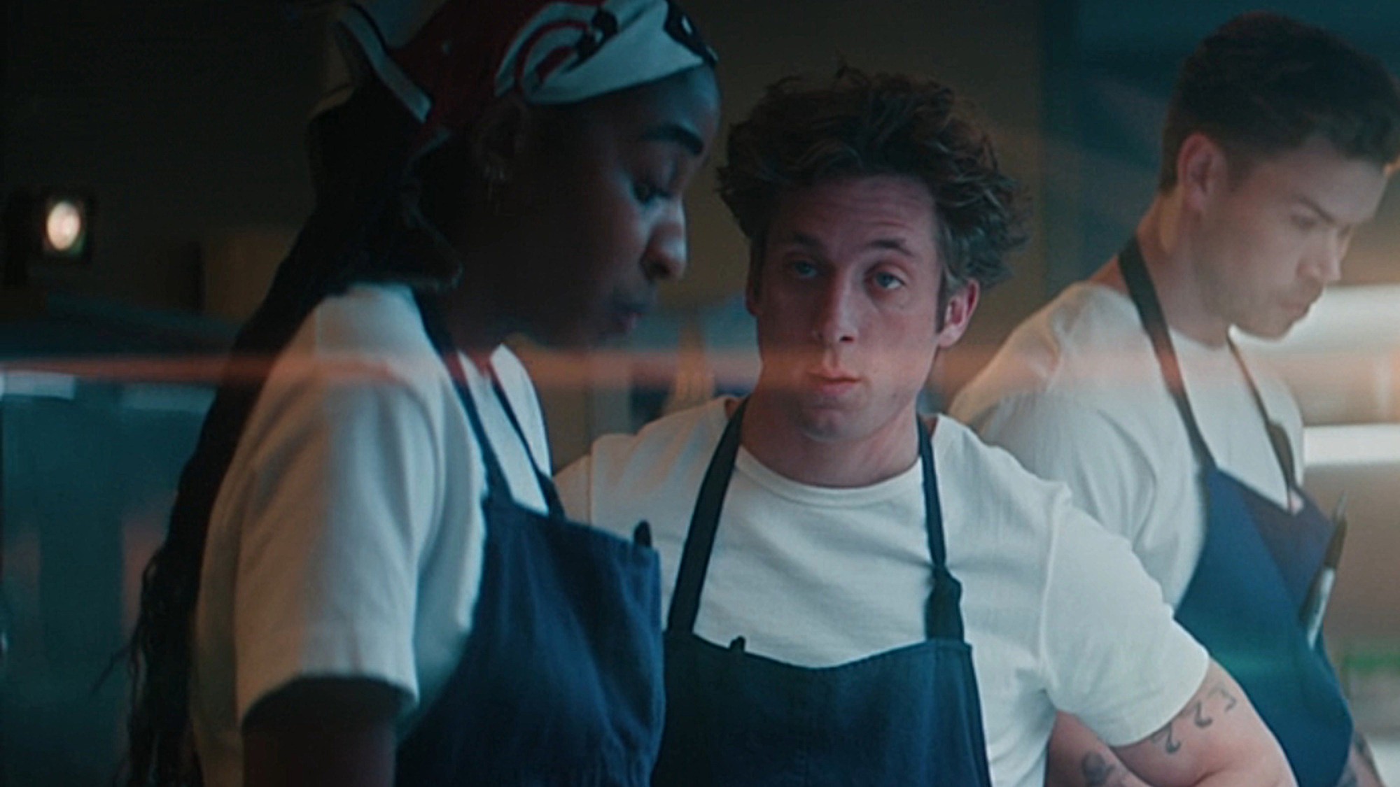Carmy (Jeremy Allen White) looks at Sydney (Ayo Edebiri) on The Bear.