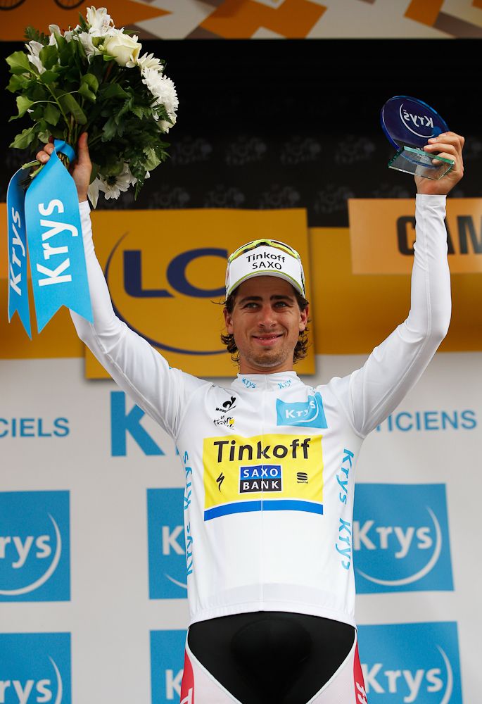 Peter Sagan is in the white jersey on the stage 4 podium.