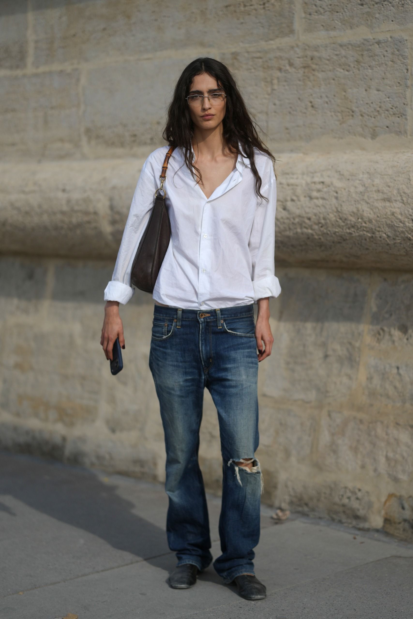 Photo of a Paris Fashion Week guest wearing French girl denim and jeans trends