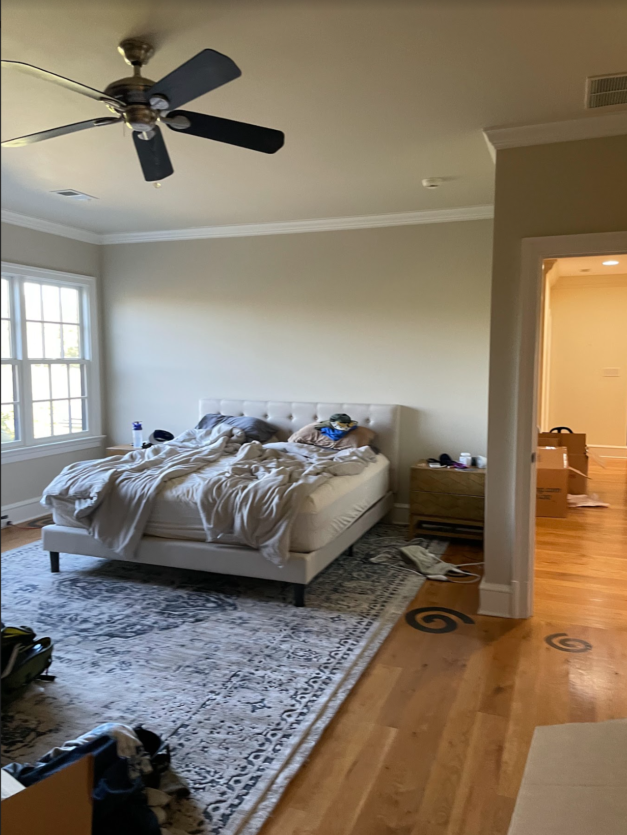 A dated bedroom with a large oriental style rug