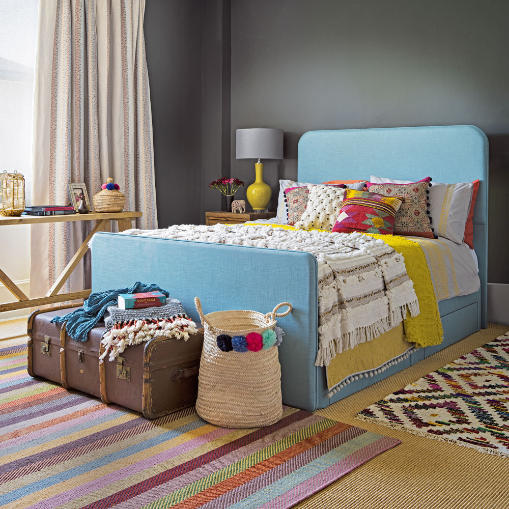 bedroom with dark grey wall and blue bed