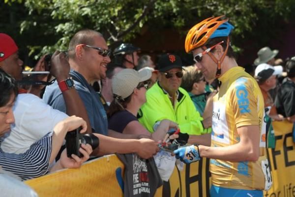 Race leader David Zabriskie (Garmin - Transitions) signs an autograph for a fan.