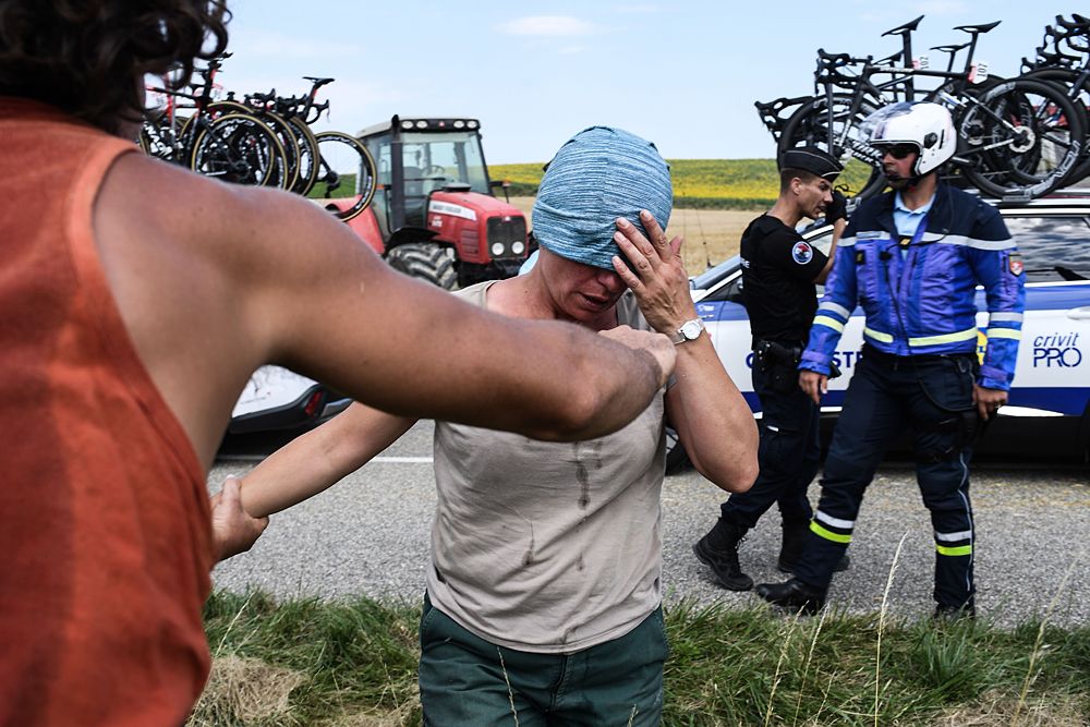 Gendarmes detain a protester during a farmers' protest who attempted to block the stage's route, during the 16th stage of the 105th edition of the Tour de France
