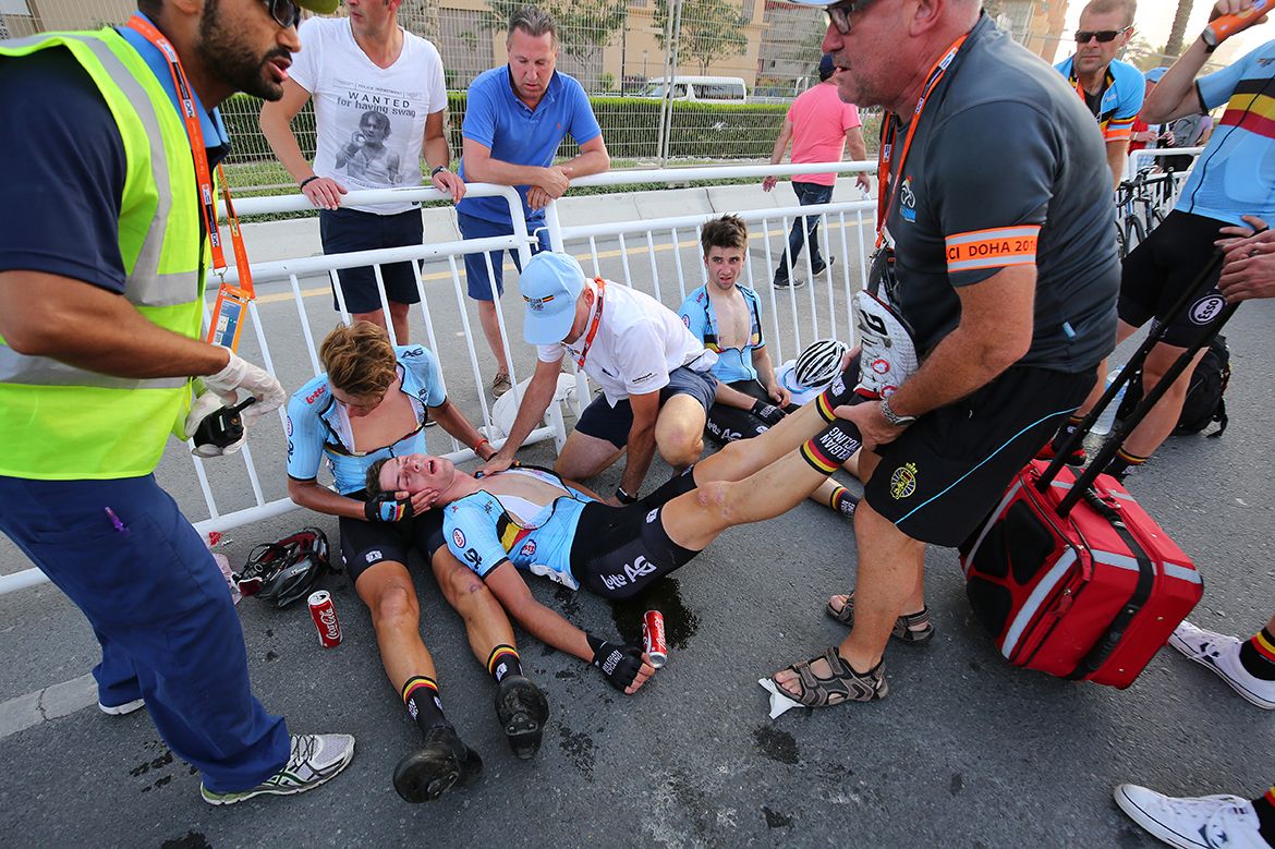 Guillaume Seye holds Enzo Wouters who fainted after the U23 race