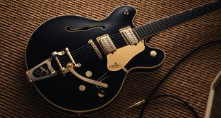 Gretsch Professional Collection Broadkaster LX Center Block: the handsome semi-hollow is finished in black with gold hardware and here is photographed in close-up.
