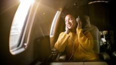 Woman silling on a plane looking out the window