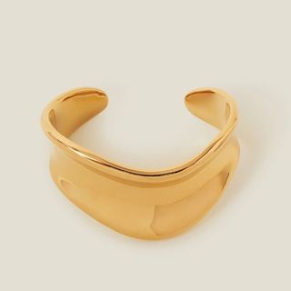 flat lay image of gold bangle