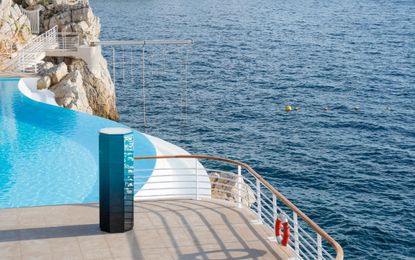 Octagon-shaped gym cabinet by Cassina with Technogym, photographed on the pool terrace by the sea at Hotel du Cap Eden Roc