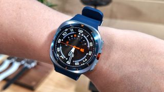 Close-up of the Samsung Galaxy Watch Ultra in the new Titanium Blue color on the writer's wrist