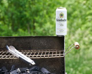 Can of beer on the corner of a BBQ