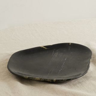 A black petrified wood platter