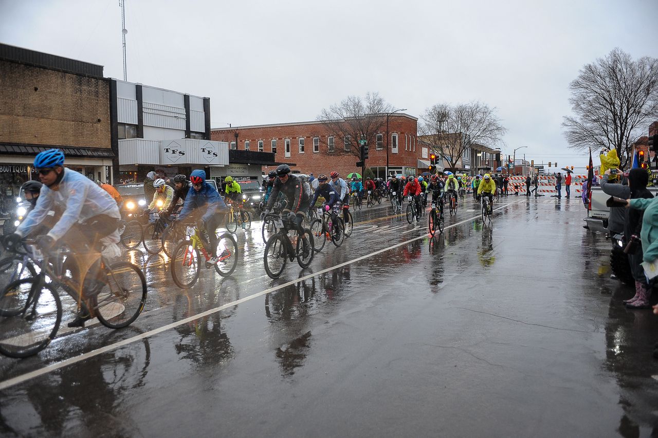 The peloton heads out into the rain