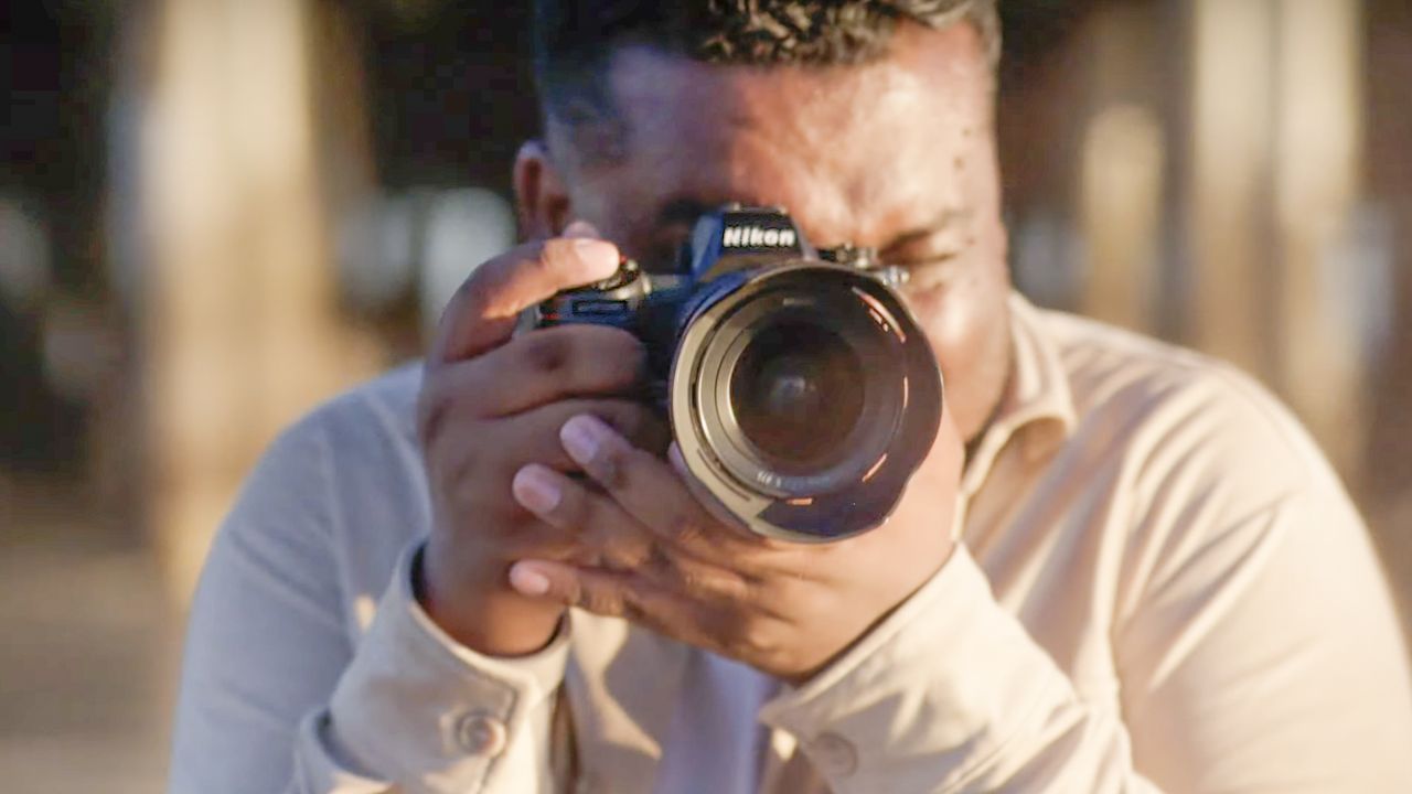 Male photographer using the Nikon Z6 III on a beach