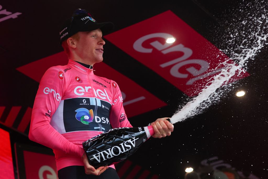 Team DSMs Norwegian rider Andreas Leknessund sprays champagne as he celebrates his overall leaders pink jersey on the podium after the fourth stage of the Giro dItalia 2023 cycling race 175 km between Venosa and Lago Laceno on May 9 2023 Photo by Luca Bettini AFP Photo by LUCA BETTINIAFP via Getty Images