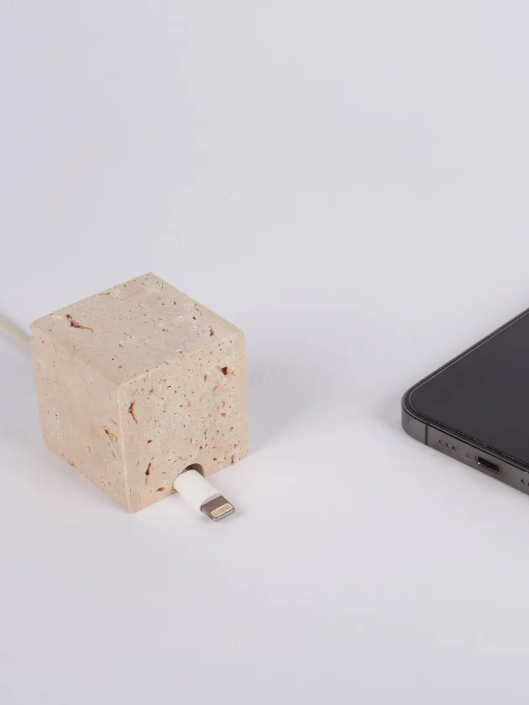 A beige travertine cable holder from Andres Stone Design on Etsy