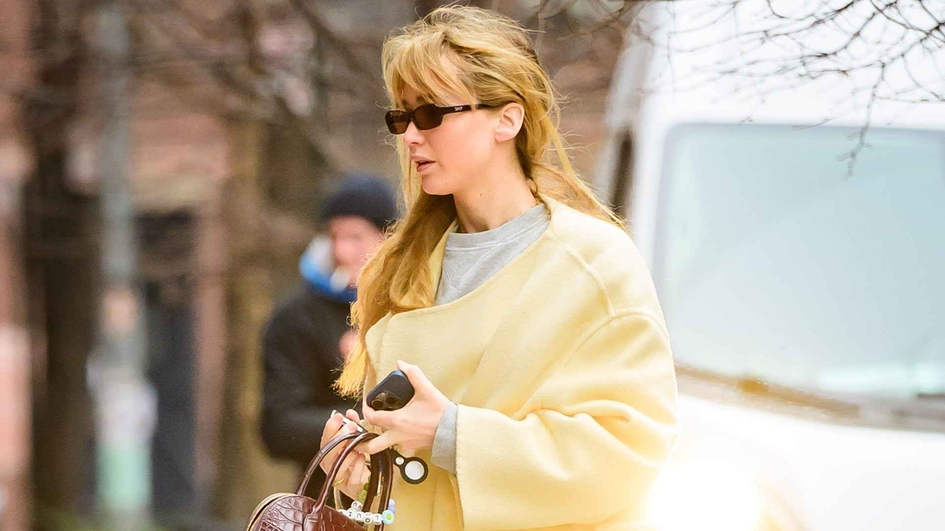 Jennifer Lawrence was spotted in a butter yellow The Row coat, black Alo leggings, Ugg boots, and The Row Lady Bag