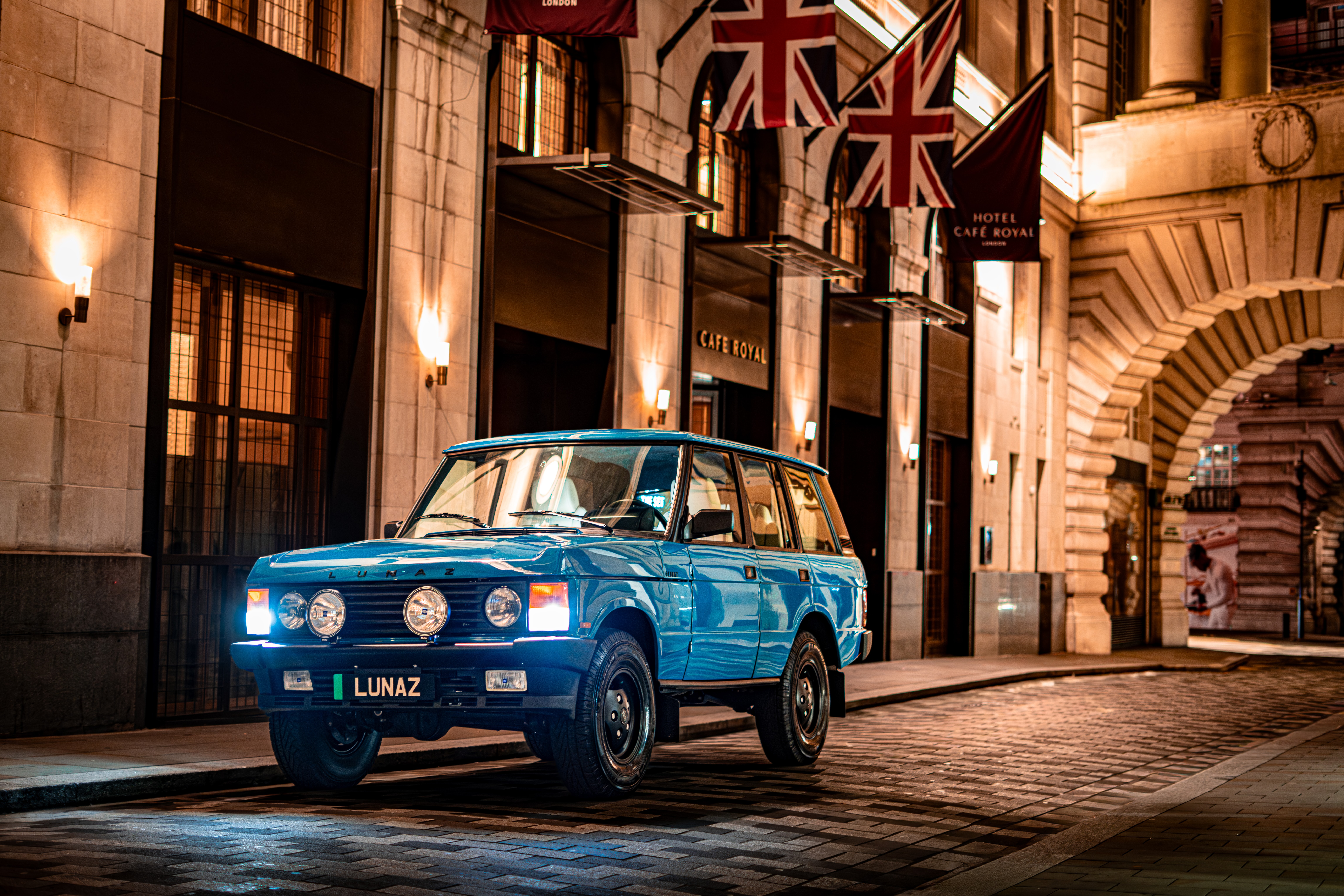 A blue Range Rover Classic by Lunaz, in front of the hotel cafe royal