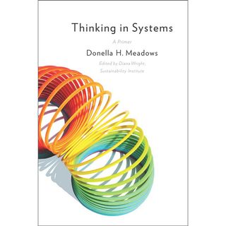 Thinking in Systems book cover shows a rainbow-coloured slinky