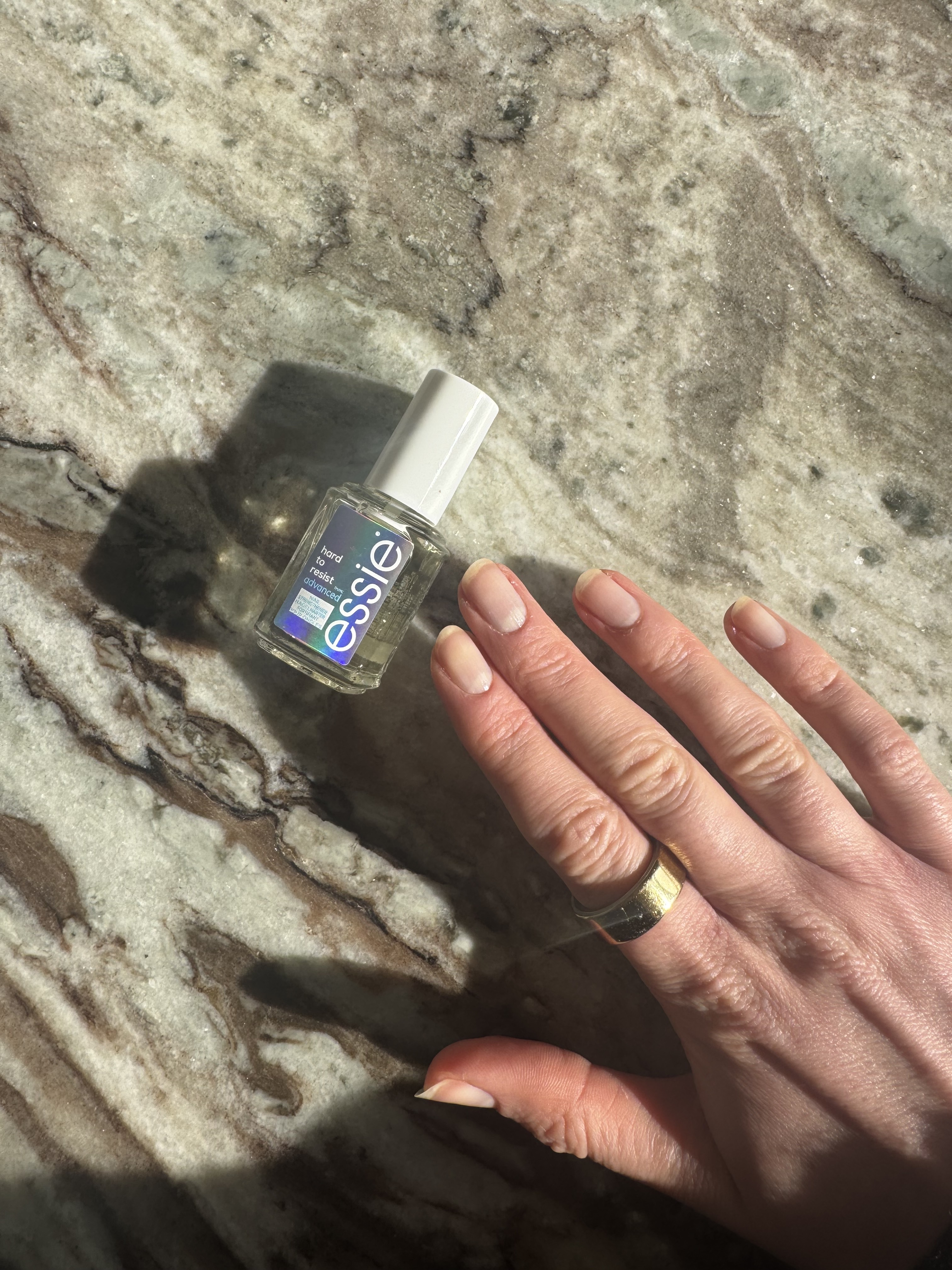 Eleanor's right hand after applying Essie Hard to Resist nail strengthener