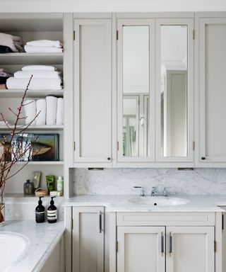 laundry room with cabinets, soap and folded towels and sheets