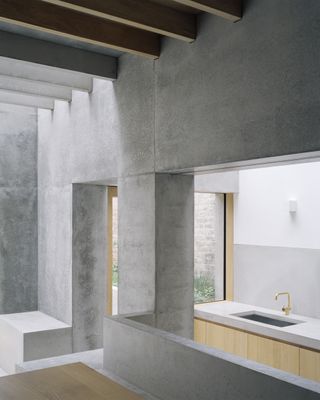 View of concrete kitchen spaces at Islington House by McLaren Excell