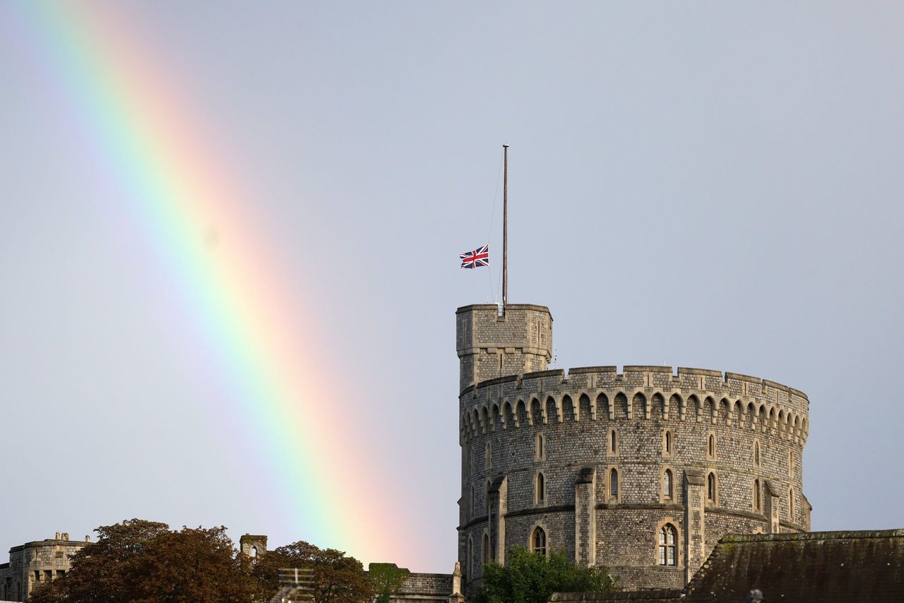 WINDSOR, ENGLAND - SEPTEMBER 08: The Union flag is lowered on Windsor Castle as a rainbow covers the sky on September 08, 2022 in Windsor, England. (Photo by Chris Jackson/Getty Images)