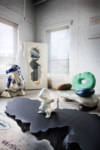 Interior of Daniel Arsham apartment with a chair from his Objects for Living II collection featuring playdough-like pebble shapes forming a chair