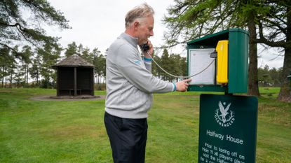 A golfer ordering food and drink from the halfway hut at Gleneagles 