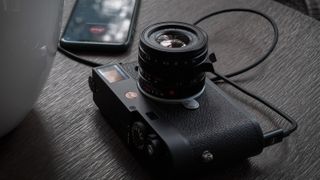 The Leica M11 camera on a wooden table