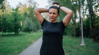 Woman tying up hair before going on a run