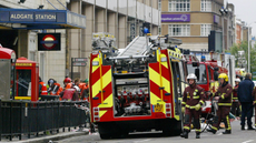 Police and fire personnel work outside London's Aldgate East tube station after an explosion occurred on 07 July, 2005. 