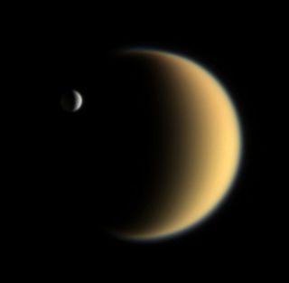 Saturn's icy moon Enceladus is seen with Titan, the largest Saturnian satellite, in the background in this view from NASA's Cassini spacecraft captured on Feb. 5, 2006. Enceladus and Titan may be attractive targets for future human explorers.