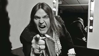 Meat Loaf in a freassing room, pointing towards the camera 