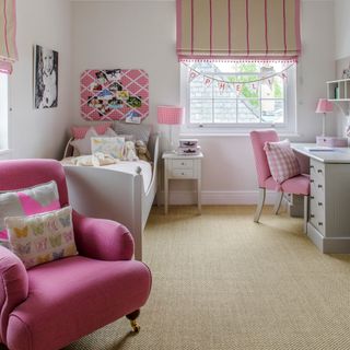 childrens room with pink armchair and white walls