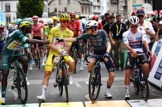 Intermarche - Wanty team's Eritrean rider Biniam Girmay wearing the sprinter's green jersey (L), UAE Team Emirates team's Slovenian rider Tadej Pogacar wearing the overall leader's yellow jersey (2nd L), Team Visma - Lease a Bike team's Danish rider Jonas Vingegaard (2nd R) and Soudal Quick-Step team's Belgian rider Remco Evenepoel wearing the best young rider's white jersey (R) await the start of the 12th stage of the 111th edition of the Tour de France cycling race, 203,6 km between Aurillac and Villeneuve-sur-Lot, southern central France, on July 11, 2024. (Photo by Anne-Christine POUJOULAT / AFP) (Photo by ANNE-CHRISTINE POUJOULAT/AFP via Getty Images)