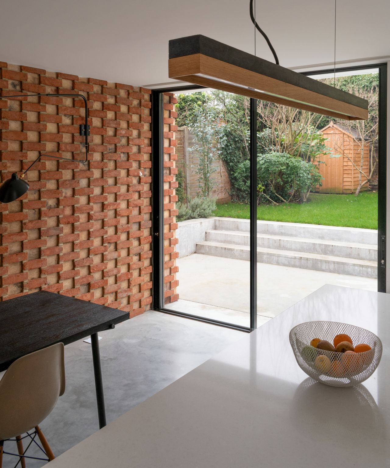 brick clad wall extending inside the new extension, with same brick finish as exterior wall