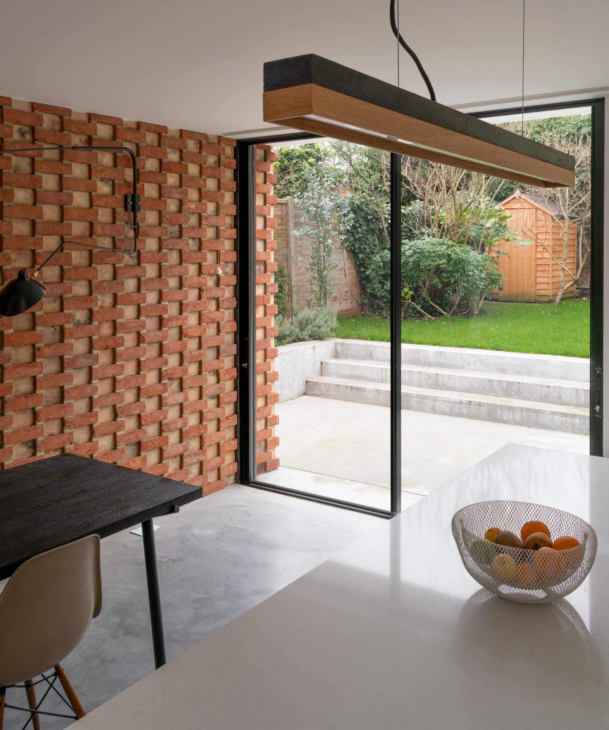 brick clad wall extending inside the new extension, with same brick finish as exterior wall