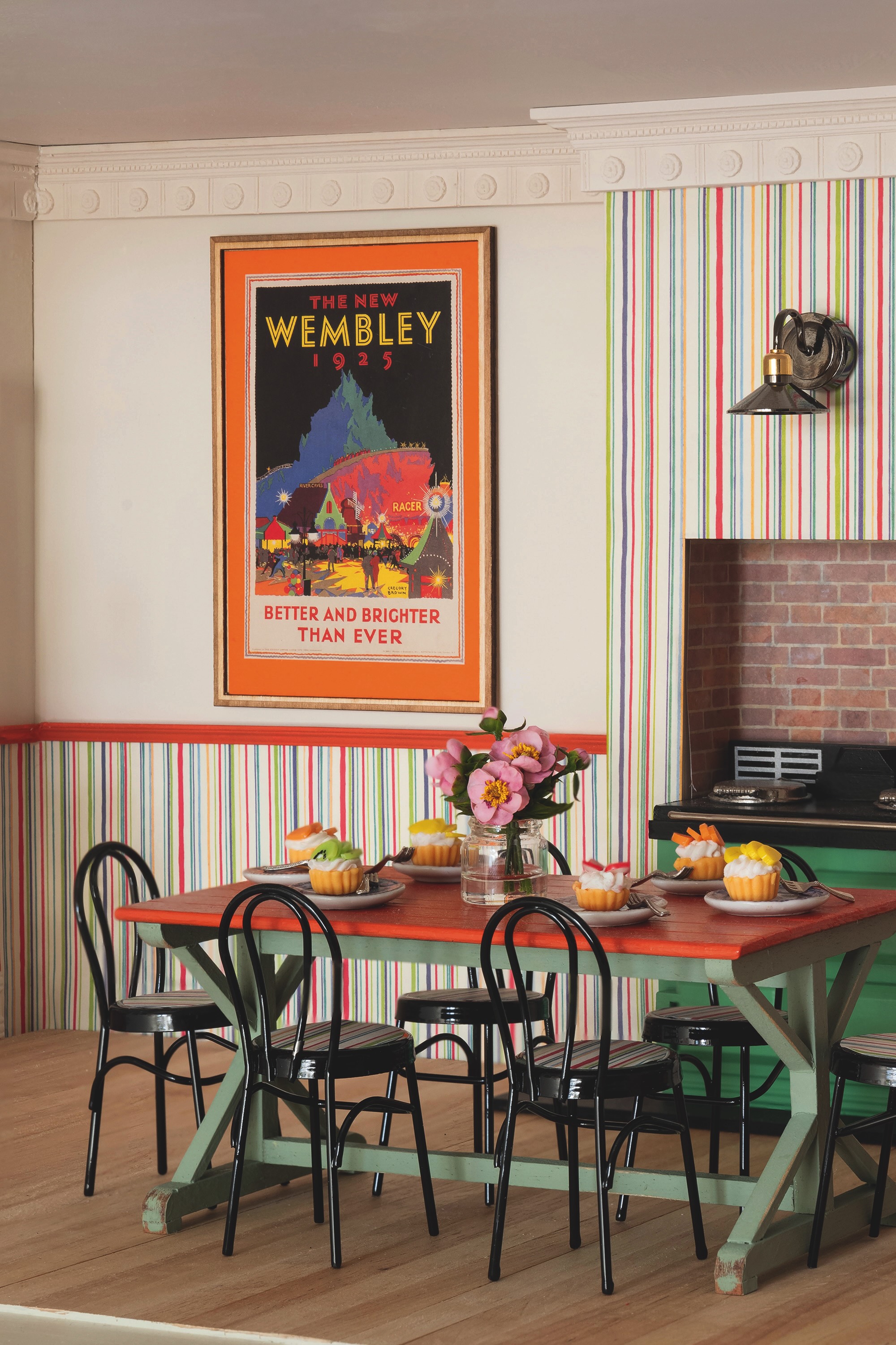 A kitchen in a dollshouse, with a vintage poster for wembley stadium and an aga