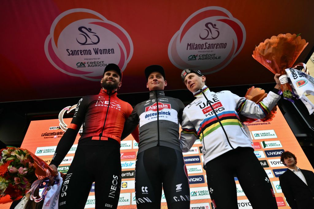 Dutch Mathieu Van Der Poel of team Alpecin-Deceuninck (C), winner, celebrates with Team Ineos' Italian rider Filippo Ganna (L), second, and Team UAE's Slovenian rider Tadej Pogacar (R), third, during the podium ceremony of the Milan - Sanremo one-day classic cycling race, on March 22, 2025. (Photo by Marco BERTORELLO / AFP)