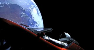 A Tesla Roadster and its mannequin driver, Starman, orbit the Earth.