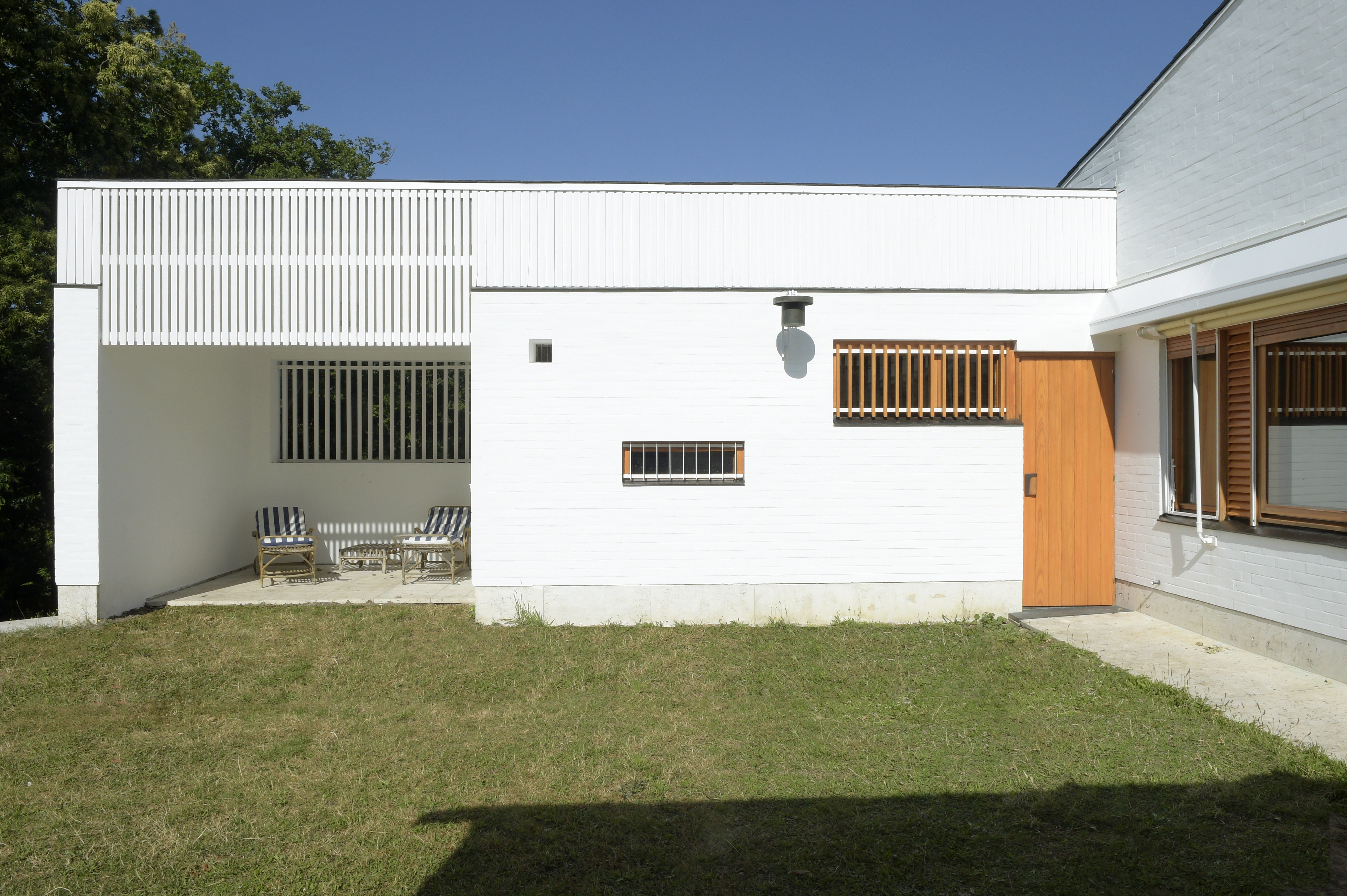 the white, clear, crisp and restored Maison Louis Carre by Alvar Aalto against blue skies