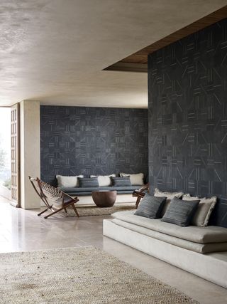 Grey pattern wallpaper with low seated benches with cushioning