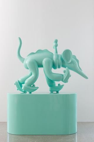 Turquoise sculpture of mouse-like creature on roller skates