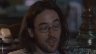 John Cusack with long hair and wearing glasses in Being John Malkovich