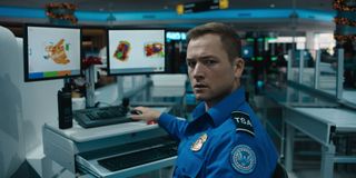 taron egerton as a tsa agent working at the airport in the movie carry on