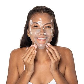 A woman with a clear Neutrogena Hydro Boost Hydrating Mask on her face
