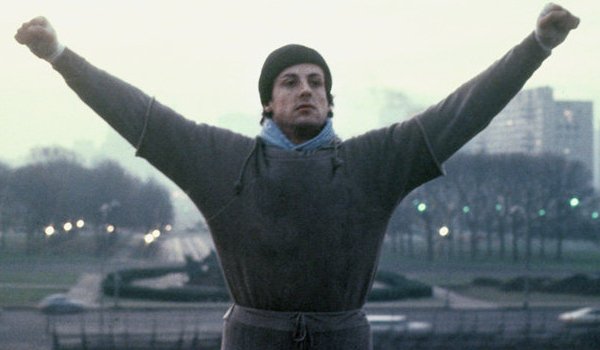 Rocky lifts his arms in victory on the Art Museum steps