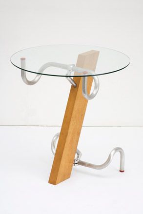 Round glass top table with base made from wood and steel