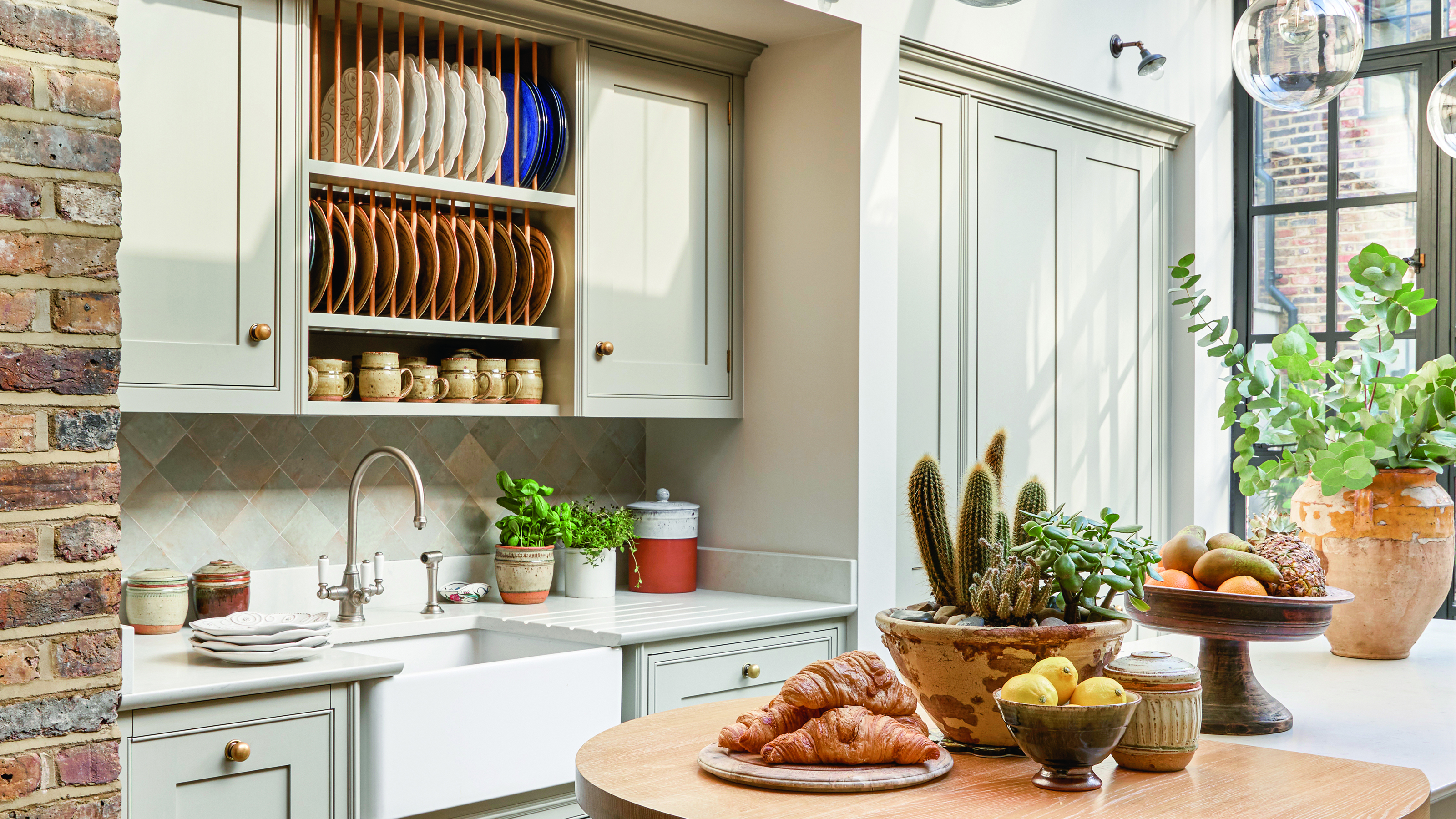 Kitchen with wall hung plate rack above sink