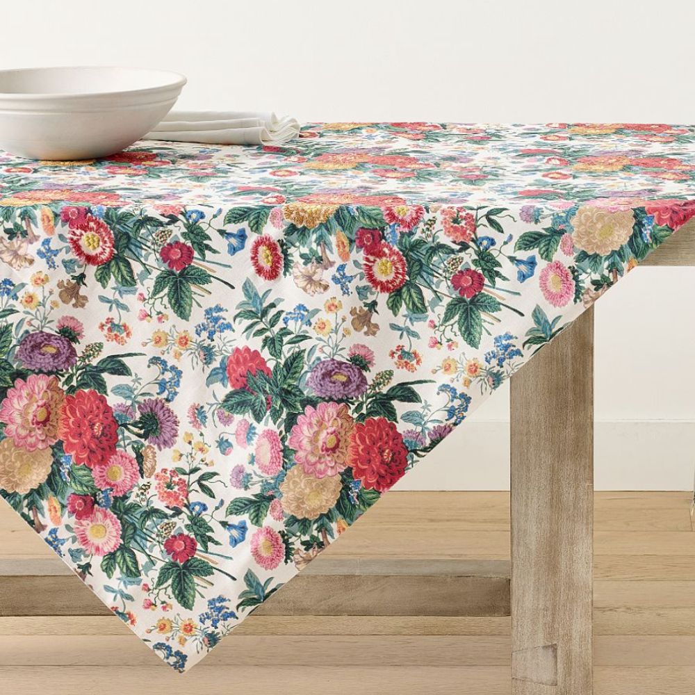Bold floral table cloth laid on a wooden table